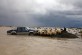 Sheep stay on a road not reached by Vjosa river water that flooded their village of Darzeze, Fier district, 115 kilometers (70 miles) south of capital Tirana, Monday, Feb. 2, 2015. Floods caused by heavy rains over the last days have hit southern Albania, forcing the evacuation of hundreds of villagers after rivers flooded thousands of hectares (acres), hundreds of homes and many roads. Many areas in southern Albania had no power or water. Police urged residents to cancel travel plans and more intense rain was forecast to hit over the next few days.  No casualties were reported.(AP Photo/Hektor Pustina)