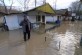 An elderly resident seeks help as he talks on his mobile phone in front of his flooded house in the town of Dalgopol, Bulgaria, Monday, Feb. 2, 2015. Torrential rainfalls, hurricane-like winds and turbulent rivers have killed at least five people during a storm that hit South-Eastern Bulgaria.  (AP Photo/ImpactPressGroup))