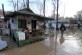 An elderly resident walks on the flooded streets in the town of town Dalgopol, Monday, Feb. 2,  2015.  Torrential rainfalls, hurricane-like winds and turbulent rivers killed at least five people during a storm that hit South-Eastern Bulgaria.  (AP Photo/ImpactPressGroup))