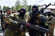 New volunteer recruits of the Ukrainian army 'Donbass' battalion pose for a photograph after taking a military oath during a ceremony of the National Guard unit near the Novi Petrivtsi village not far from Kiev, on June 23, 2014. Some 600 new volunteer recruits of the battalion, mainly representatives of the eastern Donbass region of Ukraine, who followed combat training during three weeks will take part in the military operation against armed pro-Russian militants in the east of the country. Ukraine pressed German Chancellor Angela Merkel and other Western allies today to help end a pro-Russian uprising that has continued to rage in the industrial east despite Kiev's unilateral ceasefire. AFP PHOTO / SERGEI SUPINSKY        (Photo credit should read SERGEI SUPINSKY/AFP/Getty Images)