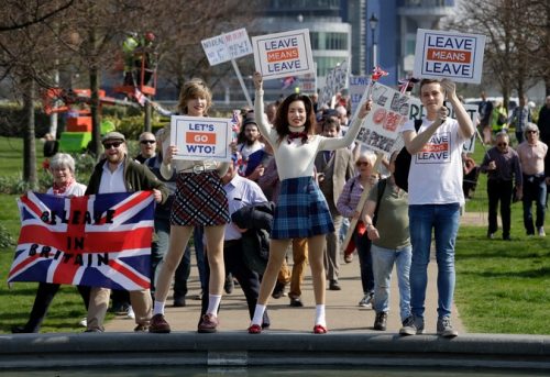 Pro-Brexit leave the European Union supporters pose for photos as they take part in the final leg of the "March to Leave" in London, Friday, March 29, 2019. The protest march which started on March 16 in Sunderland, north east England, finishes on Friday March 29 in Parliament Square, London, on what was the original date for Brexit to happen before the recent extension. (AP Photo/Matt Dunham)