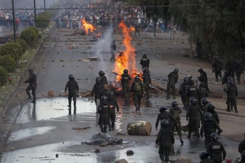 Police dismantle a barricade constructed by supporters of former President Evo Morales, on the outskirts of Cochabamba, Bolivia, Saturday, Nov. 16, 2019. Officials now say at least eight people died when Bolivian security forces fired on Morales supporters the day before, in Sacaba. The U.N. human rights chief says she's worried that Bolivia could "spin out of control" as the interim government tries to restore stability following the resignation of the former president in an election dispute. (AP Photo/Juan Karita)