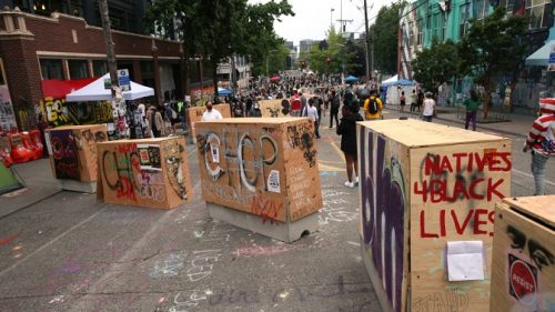 SEATTLE, WA - JUNE 19: Barricades erected by the city several days ago divide up the CHOP zone on June 19, 2020 in Seattle, Washington. The concrete barriers, wrapped in plywood for painting, were installed to protect the free speech zone while still allowing one lane of traffic to get through. Nevertheless, protesters have blocked off entrances to traffic. (Photo by Karen Ducey/Getty Images)