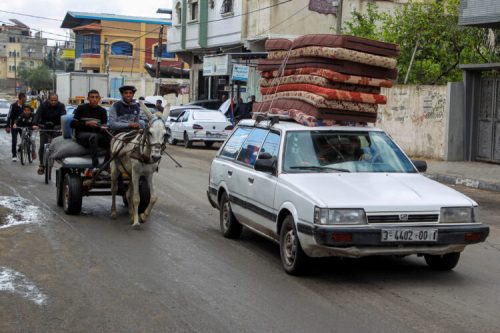 People flee the eastern parts of Rafah after the Israeli military began evacuating Palestinian civilians ahead of a threatened assault on the southern Gazan city